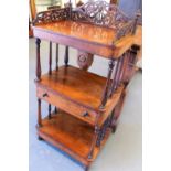 Victorian rosewood three-tier wotnot, the pierced foliate scroll gallery over eight turned