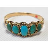 Edwardian yellow metal turquoise set five stone ring, the graduated cabochon stones in a scroll