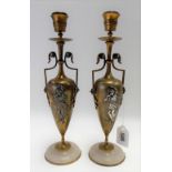 Pair of bronze and silvered twin handled urn candlesticks with a circular onyx base, height 30cm.