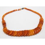 Unusual butterscotch amber disc and circular bead graduated necklace with 9ct gold clasp, length