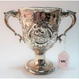 Georgian Irish silver twin handled pedestal cup, foliate scroll embossed and with engraved