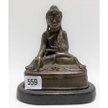 Bronze model of Buddha with glass inset eyes and on a wood base, height 18cm.