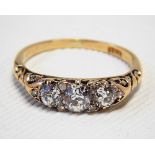 18ct gold & diamond ring, set with three diamonds & five chip diamonds, the central stone of 0.