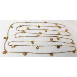 A Middle Eastern high purity gold long necklace mounted with small imitation coins spaced with