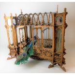 Early 20th Century fretwork bird cage of architectural form with glass panels, width 46cm (areas