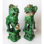 Two Chinese pottery green glazed Fo dog incense burners, height 24cm