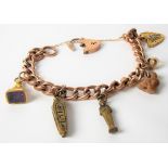 9ct rose gold curb link bracelet applied with a 9ct gold charm and three base metal charms, weight