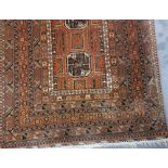 Afghan rug with three central medallions and within multiple geometric borders upon an orange