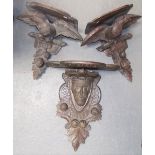 Pair of Black Forest carved wall brackets, the supports carved as eagles, width 31cm; together