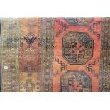 Afghan rug with three central medallions within multiple borders upon an orange ground, width