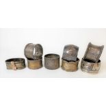 Seven various silver hallmarked napkin rings; together with a white metal Niello napkin ring, weight