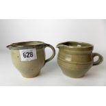 Two St Ives Leach Studio Pottery cream jugs, one with celadon glaze, the other with a mottled grey