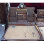 An early 20th Century Westcountry advertising stationery rack with folding writing surface &