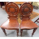 Pair of Victorian mahogany balloon back carved hall chairs