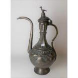 Middle Eastern tinned copper hinged lidded coffee pot, the lid with bird finial, the ovoid body