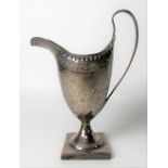George III silver pedestal cream jug with floral swags and vacant cartouche upon a square base,