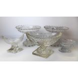 Five items of 19th Century glass, including a pair of cut and faceted tazzas, a boat-shaped pedestal