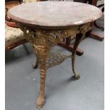 Victorian wrought metal circular table, the circular stained wood top over three cabriole legs