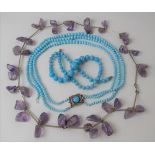 An amethyst & silver metal necklace together with two turquoise bead necklaces