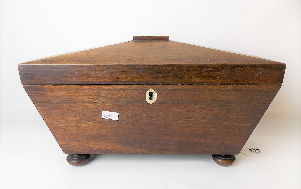 19th Century mahogany tea caddy of sarcophagus form, the hinge-lid revealing three compartments with