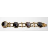 Early 19th Century pinchbeck banded agate cabochon four stone bracelet interspersed with two rows of