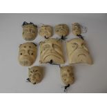 Interesting collection of nine early 20th Century African tribal carved ivory miniature masks, the