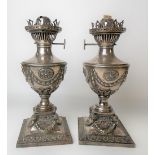 Pair of Victorian silver plated neo-Classical-style urn oil lamps cast with harebells and ram head