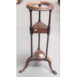 19th Century mahogany three-tier powder stand, the circular turned supported on three turned