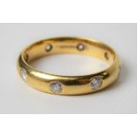 18ct hallmarked gold diamond set band ring, rub over set with eight brilliant cut diamonds of 0.05ct