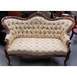 Victorian walnut framed buttonback upholstered settee with foliate carved upholstered armrests