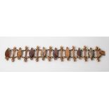 19th Century gold plated hardstone bracelet with eight polished multi stones of navette form