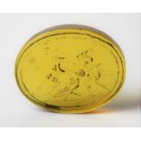 Antique oval unmounted yellow stone intaglio, depicting three gladiators in combat, a lion on