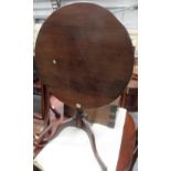 George III mahogany tilt-top pedestal tripod table with baluster ring turned pedestal upon three