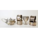 Four silver hallmarked napkin rings; together with a hinge lidded mustard pot with embossed ribbon
