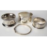 Three hallmarked silver napkin rings; together with a child's sterling silver bangle, weight overall