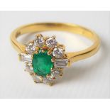 Modern 18ct hallmarked gold diamond and emerald cluster ring, the central oval emerald of 0.30ct