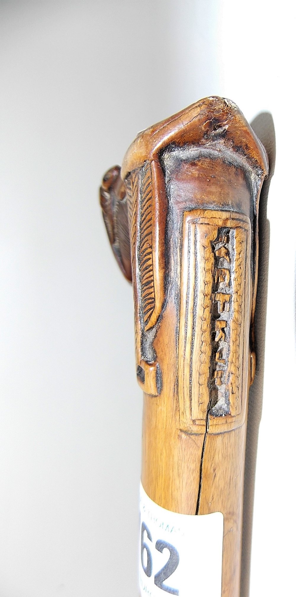 Carved wood walking cane, the handle carved as a horse head & saddle, the back with a tablet - Image 4 of 4