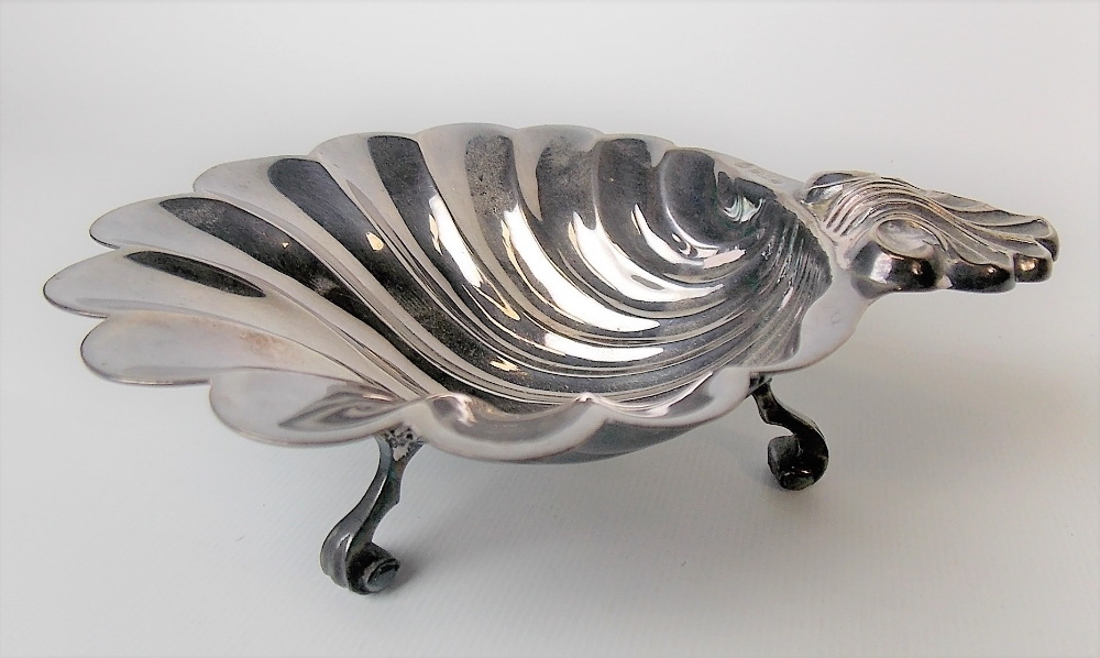 Modern silver scallop shell moulded dish raised on triple scroll feet, maker FH, Sheffield 1971,