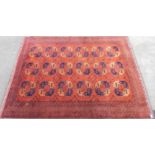 Middle Eastern carpet with three rows of six medallions within multiple borders upon a red ground,