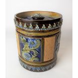 Doulton Lambeth tobacco jar and cover, tube lined decorated with panels of flowers upon a blue