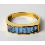 18ct gold pale blue stone set eight stone ring, the stones baguette cut, weight 3.4g approx.