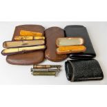 Collection of antique smoking-related items, including two amber cheroot holders, an ivory gold