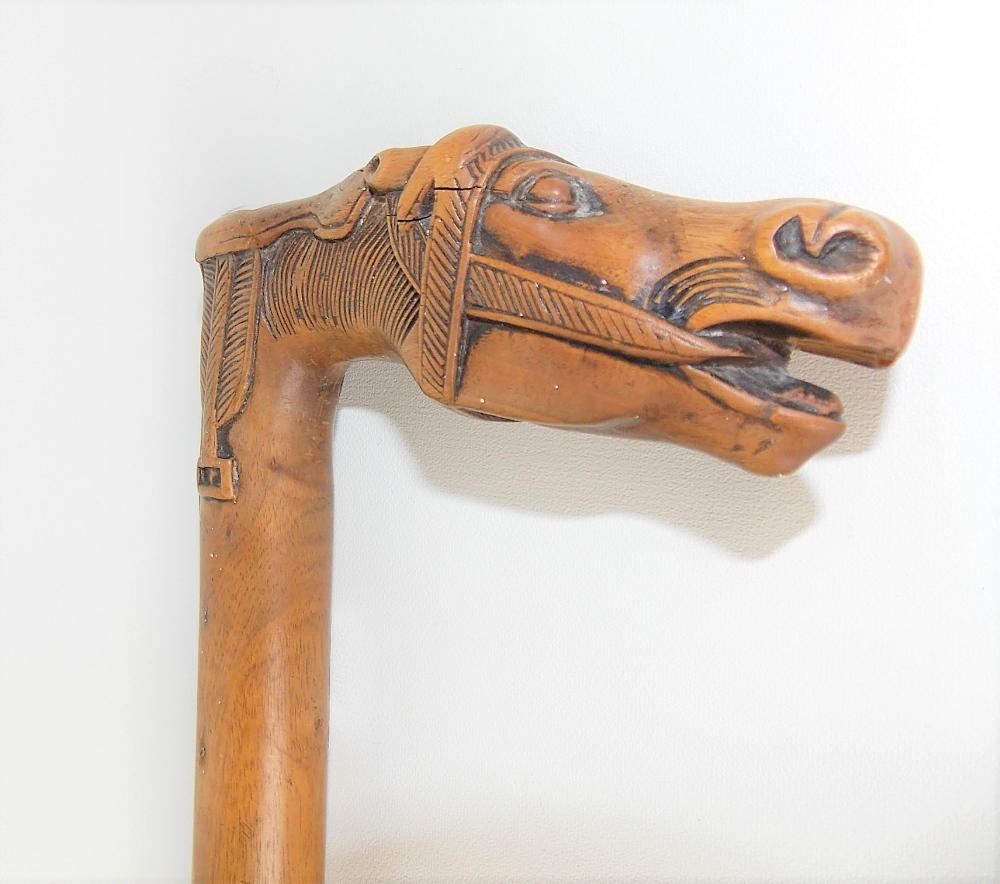 Carved wood walking cane, the handle carved as a horse head & saddle, the back with a tablet - Image 3 of 4