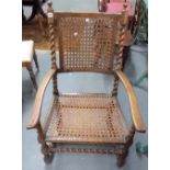 17th Century style walnut elbow chair with canework back & seat & with barley twist supports