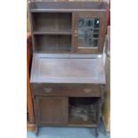 Oak Arts & Crafts low bureau bookcase retailed by Liberty of London, the raised back with two