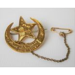 High carat gold Eastern star & crescent brooch engraved with a building & domed building & palm