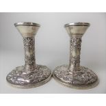 Pair of modern silver embossed squat weighted candlesticks, height 9.5cm, Birmingham 1971