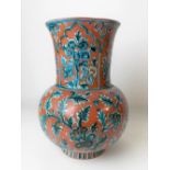 A Persian Iznik earthenware ovoid vase with flared neck, foliate scroll painted in blue & white upon