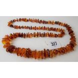 An irregular shaped amber bead necklace, weight 86.4g approx.