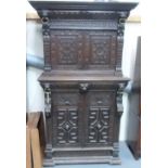 19th Century Continental oak two-section cupboard, the top with moulded cornice over carved lion